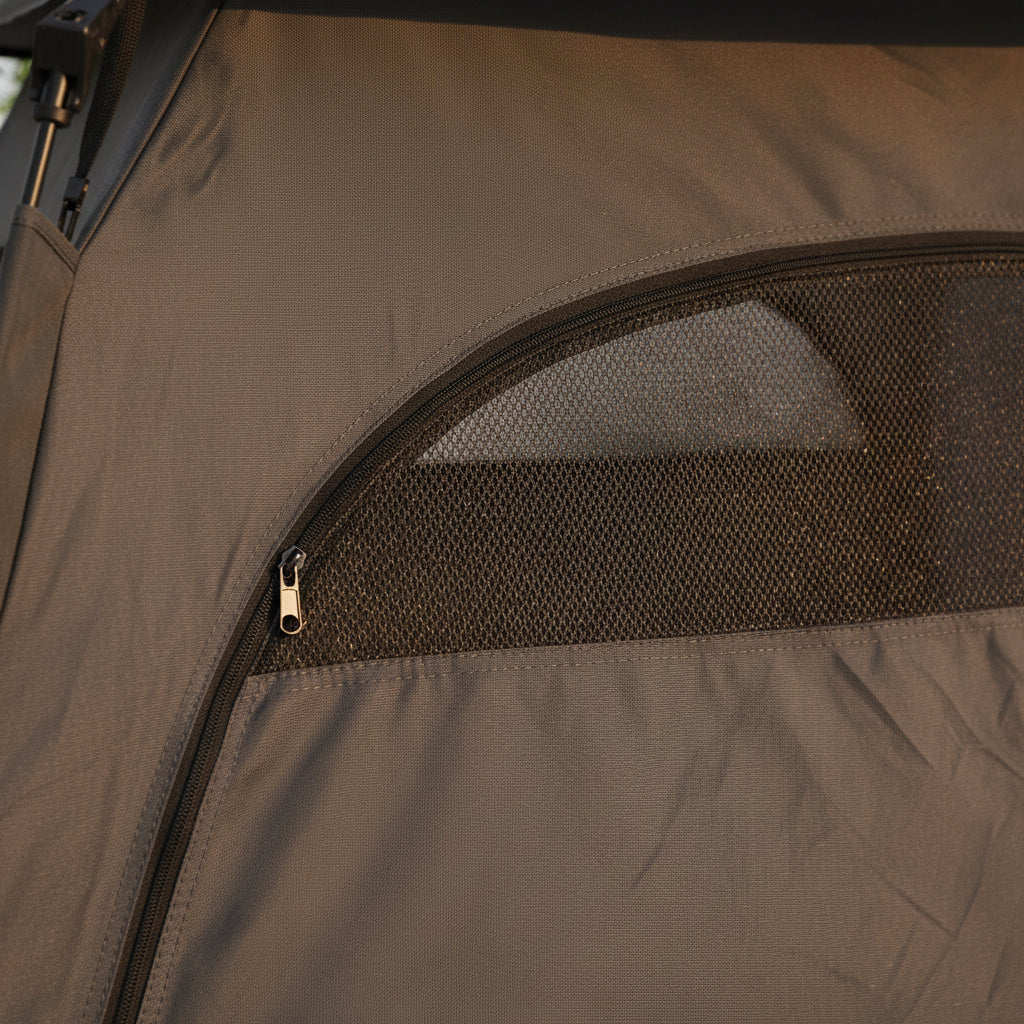 Foldable outdoor dog den packed into its carry bag